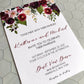 Wedding invitation card with floral design on a textured surface