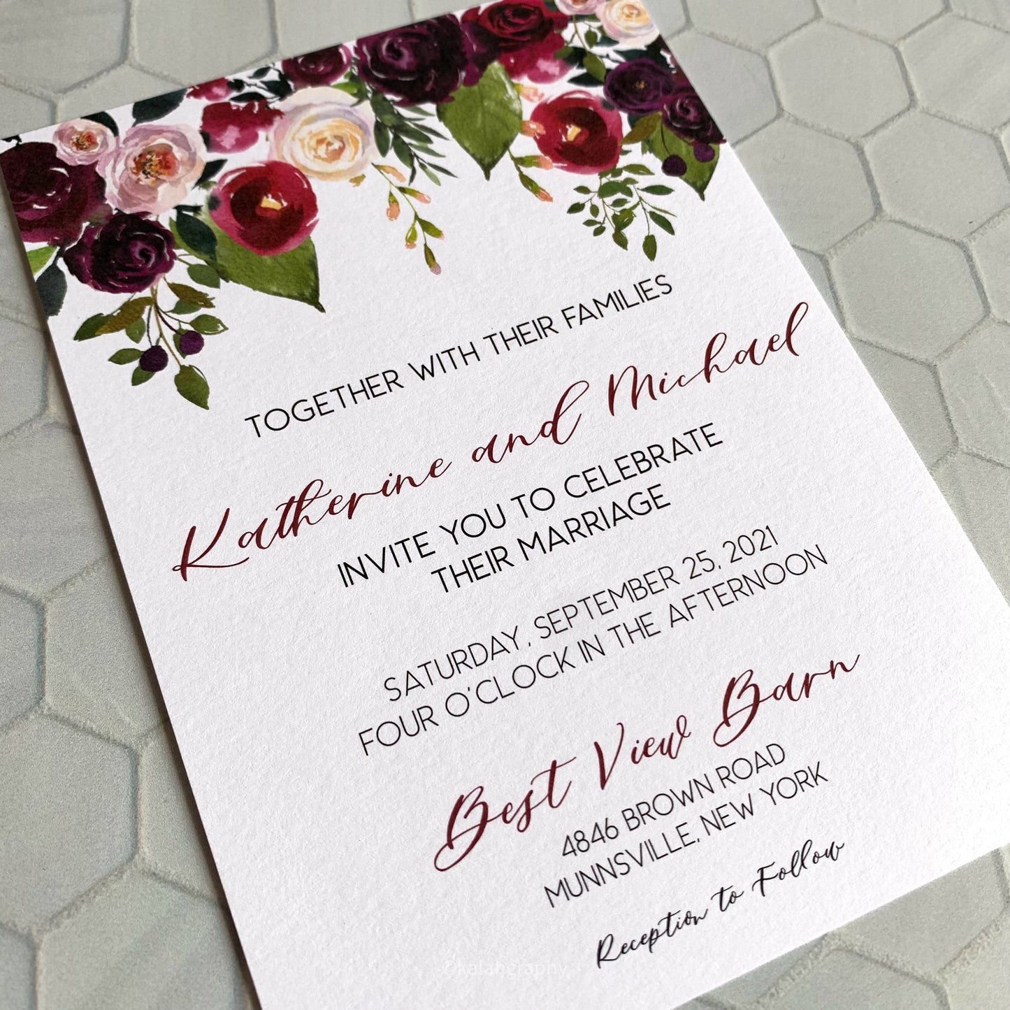 Wedding invitation card with floral design on a textured surface