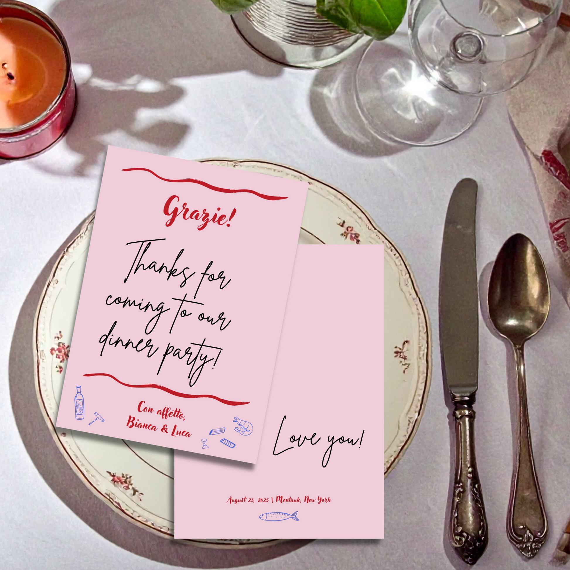 Pink thank you card on a dinner party table with cutlery and candle