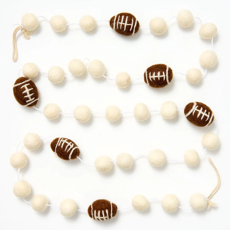 Decorative garland with white and brown football-shaped beads on a white background