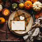 Thanksgiving table setting with pumpkins, candles, and a 'What I'm Thankful For' card.