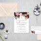 Wedding invitation set with floral design on a gray surface