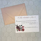 Invitation card with floral design and envelope on a hexagonal tile background
