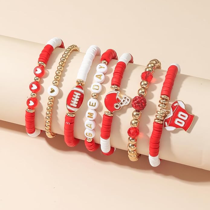 Set of red and gold football games bracelets on a beige surface